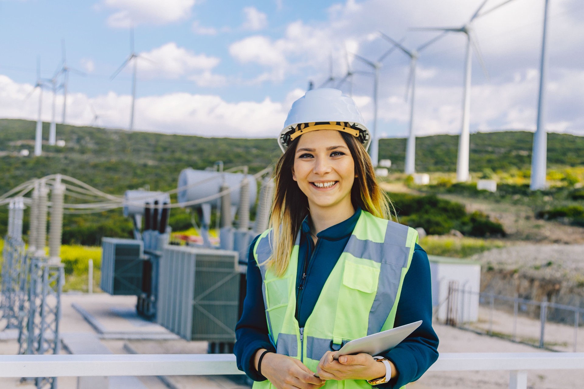 Portrait of young confident female engineer in electric power station